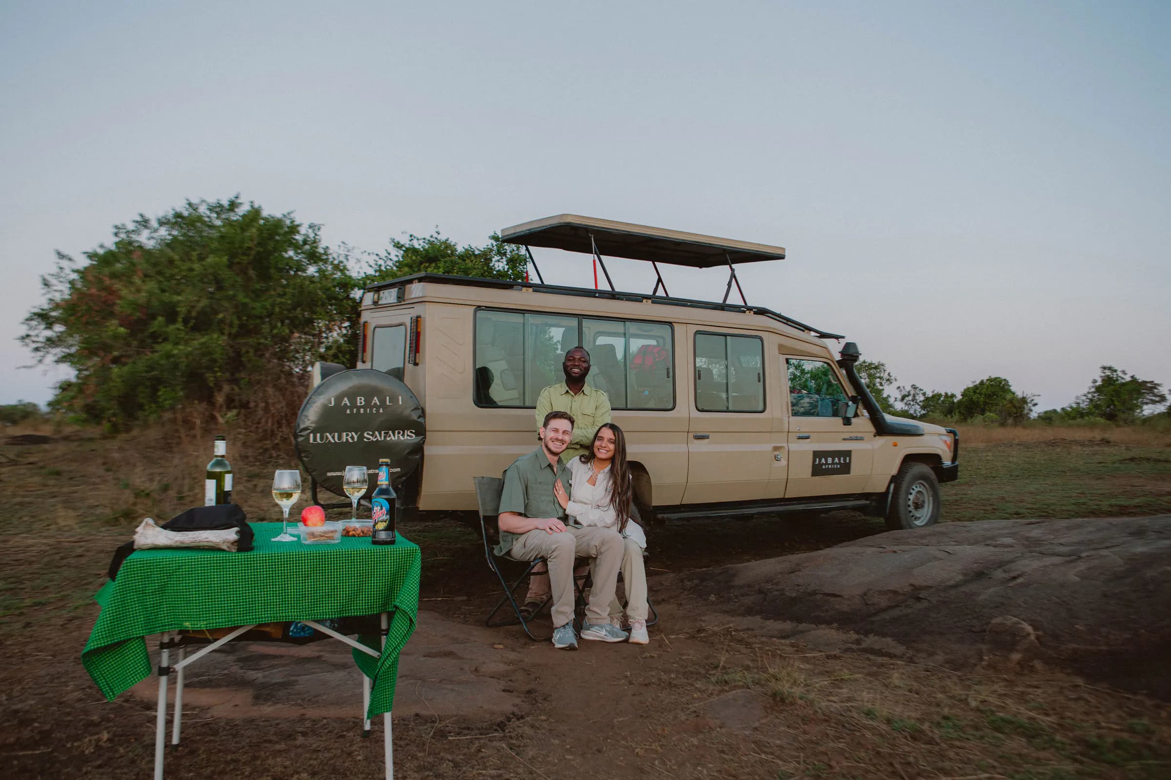 Guests and their guide beside a private Jabali Land Cruiser on the plains