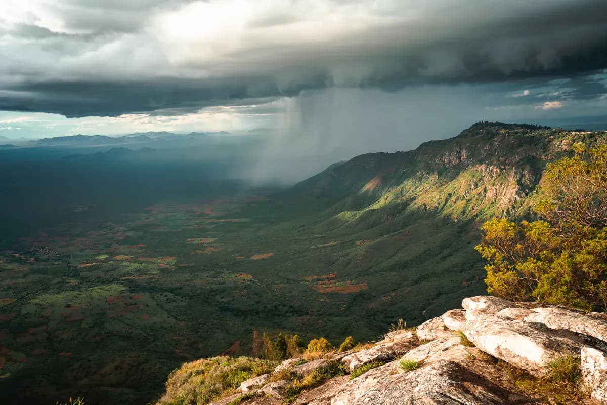 View from an escarpment over the valley under a passing storm