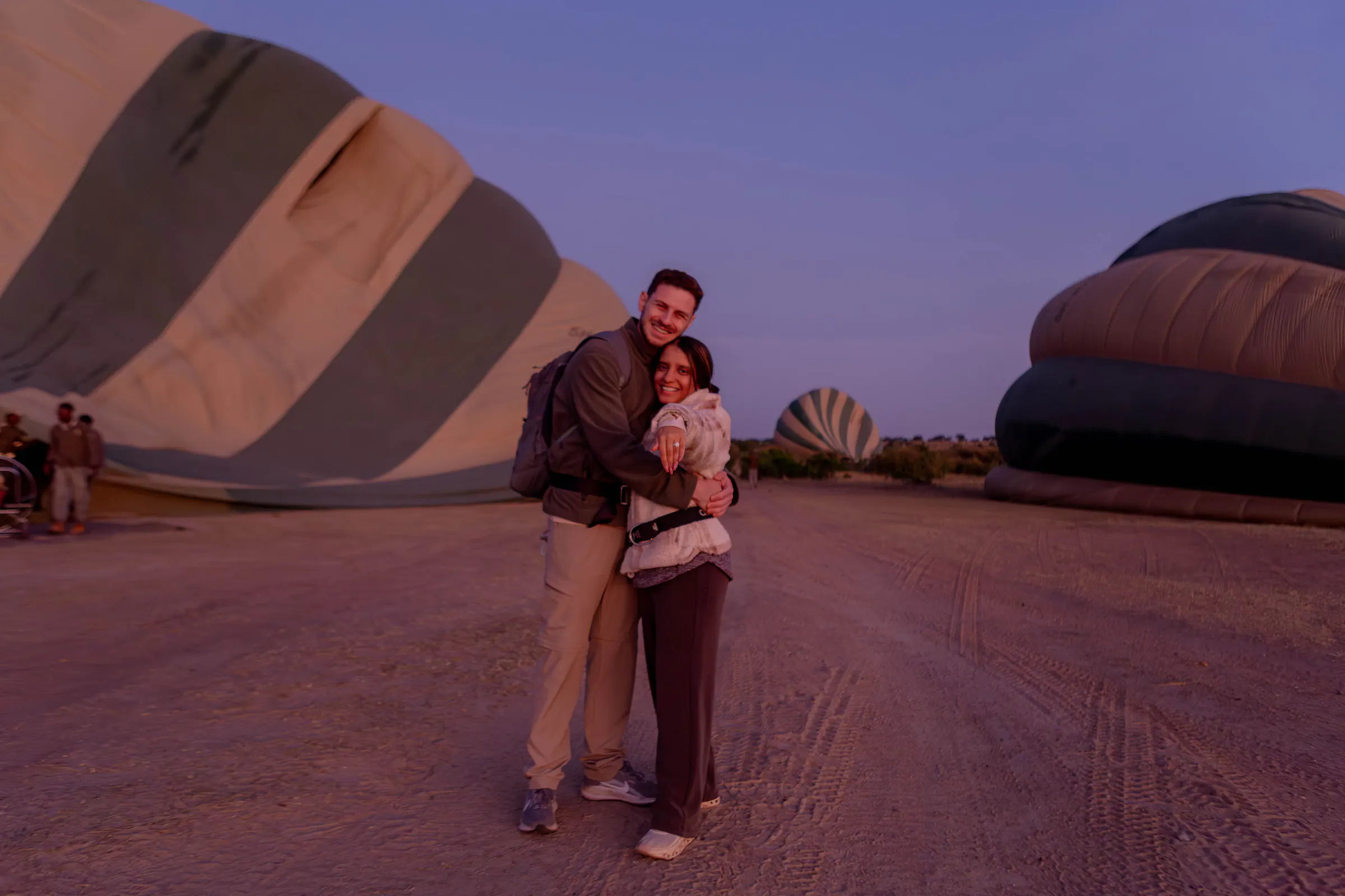Couple at a hot-air balloon launch at dawn
