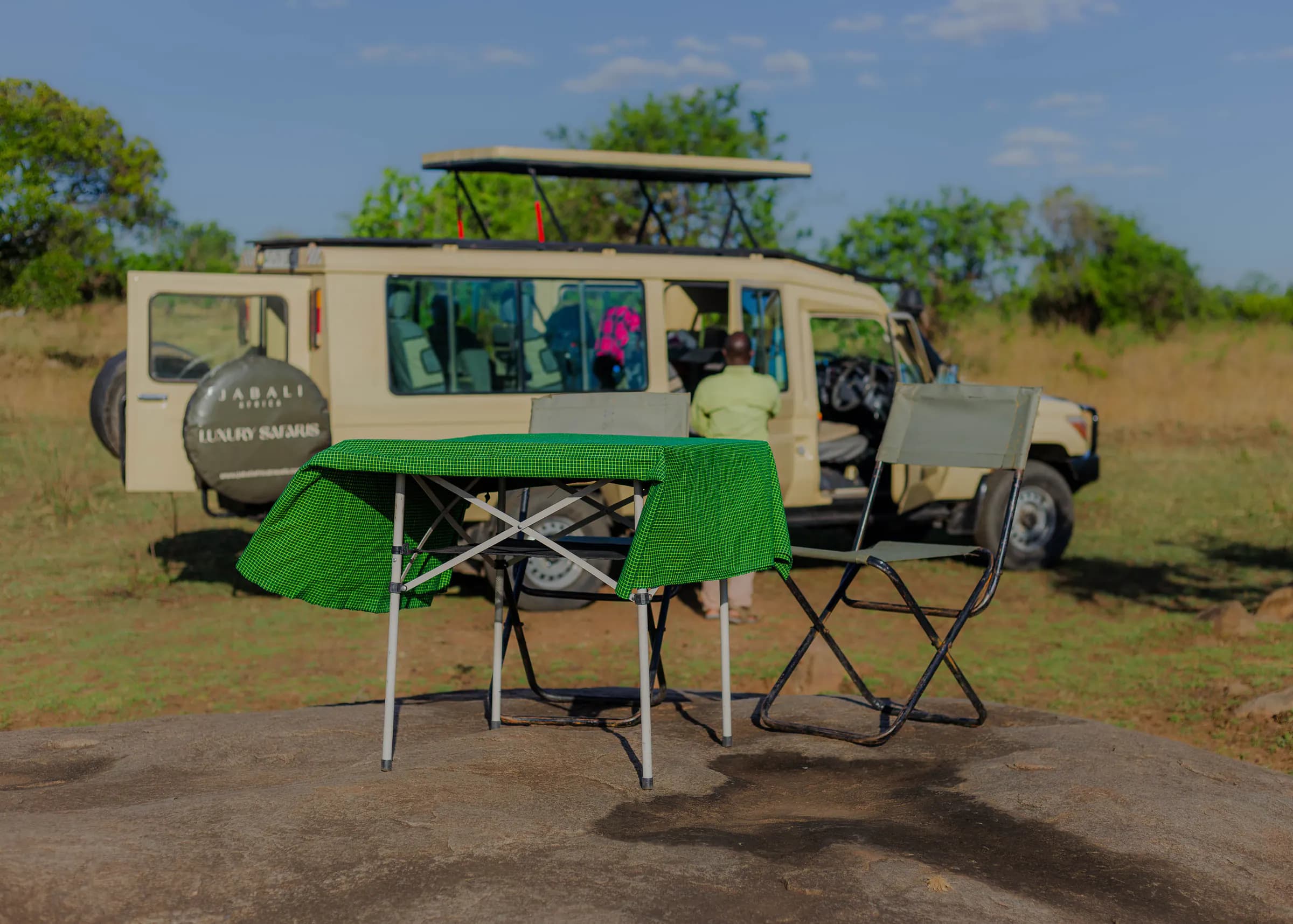 Jabali Land Cruiser with pop-up roof and a picnic table set on the plains